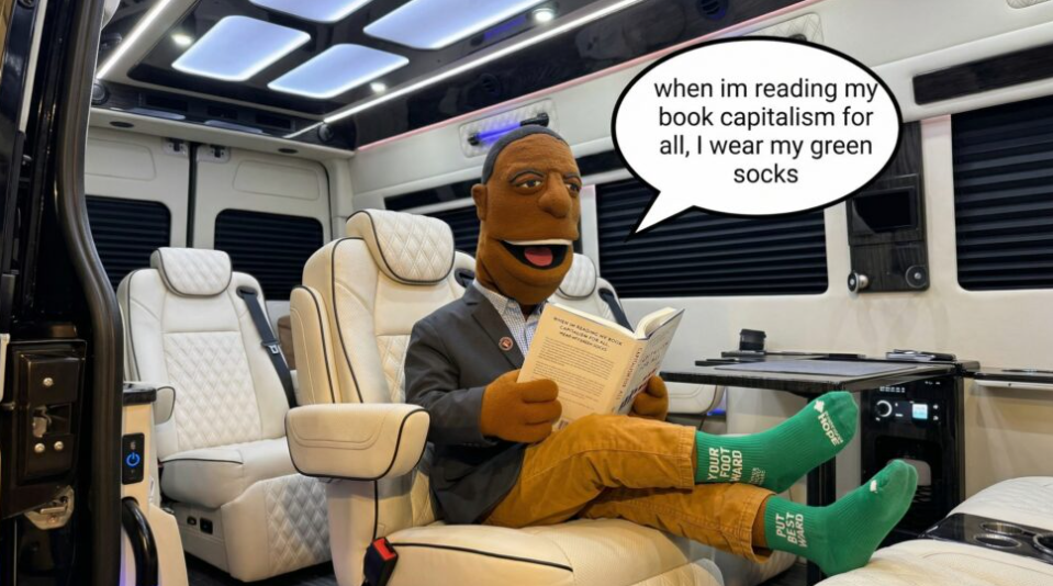 Financial Ed puppet reading Capitalism for All in a luxury vehicle